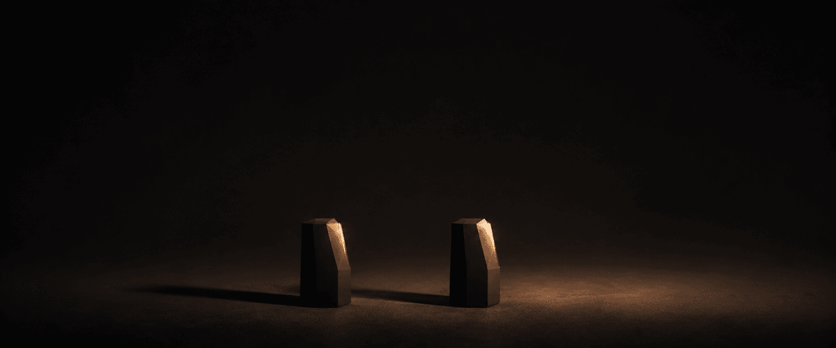 Two nearly identical dark forms standing side by side under the same warm light, echoing how closely one business's website can end up mirroring a competitor's