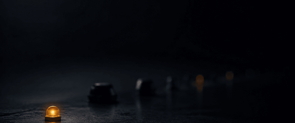A single small lamp glowing in sharp focus at the front of a dark scene, while a line of other shapes and dimmer lights blurs into the darkness behind it — echoing how a website's first sentence stands out clearly ahead of everything else on the page