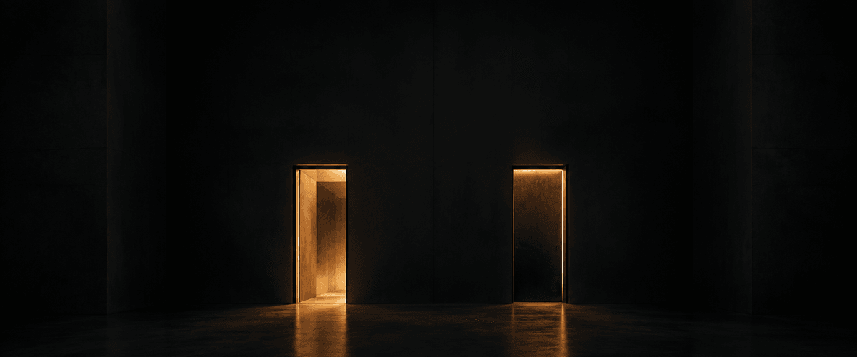 Two identical doorways lit with the same warm light in a dark space — one opens into a deep, visible room beyond it, the other's light stops short at a wall just behind the opening