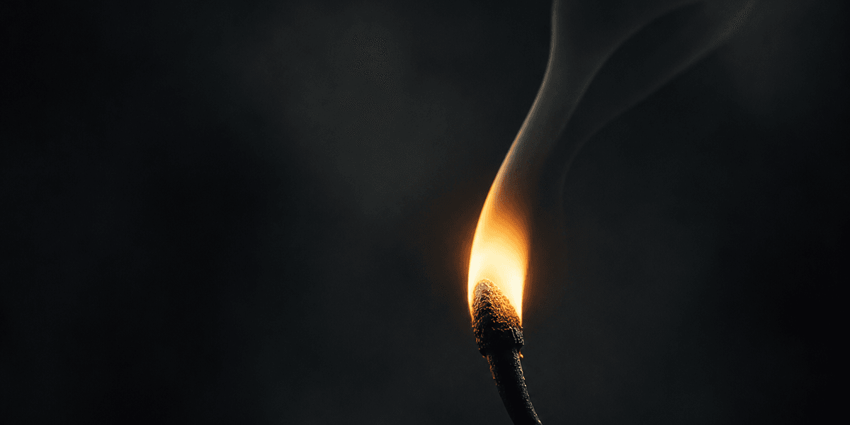 A single match flame burning low in the dark, its thin trail of smoke suggesting how easily the smallest disturbance could put it out — echoing how easily a small misstep can unsettle a visitor's trust