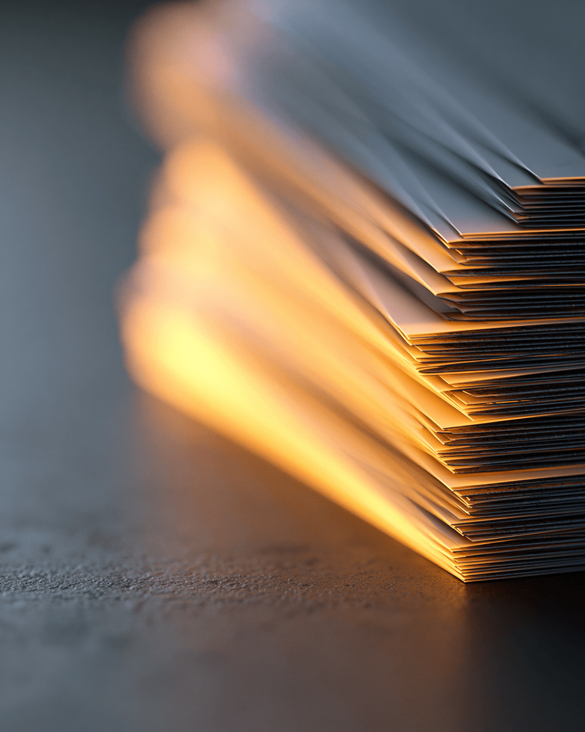 Stack of fanned cash bills, edge-lit