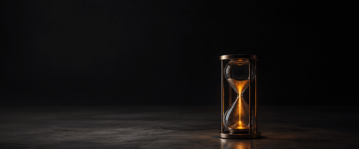 An hourglass quietly marking time passing unattended, representing the cost of delaying a known fix