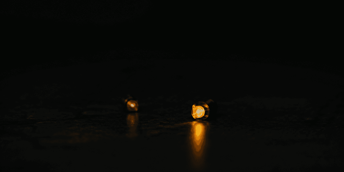 A narrow beam of light cutting through darkness toward a single illuminated point, representing the small number of searches that actually find their way to a business that isn't built to be discovered
